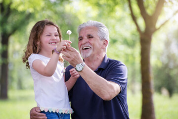 Obraz premium Grandfather with Granddaughter at park
