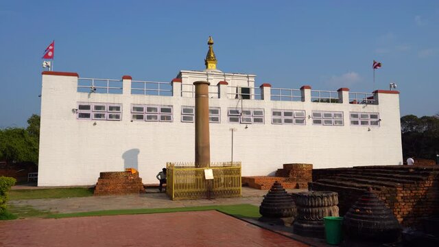 A view of the pillar established by King Ashoka in Lumbini at the birthplace of Siddhartha Gautama, who later became Buddha Shakyamuni. In the background is the Mayadevi temple.