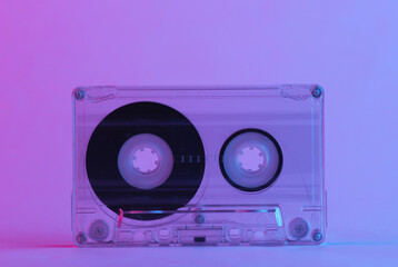 Retro audio cassette in trendy neon light. Gradient pink-blue glow. Concept art. Minimalism