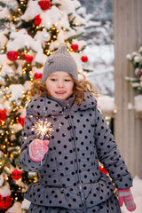 Teenager girl with sparkler in winter.