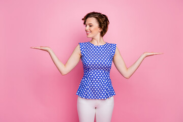 Portrait of her she nice-looking attractive lovely pretty cheerful cheery wavy-haired girl holding on two palms advert copy space alternative options isolated over pink pastel color background