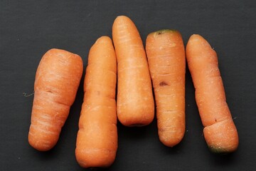 baby carrots on black isolated background