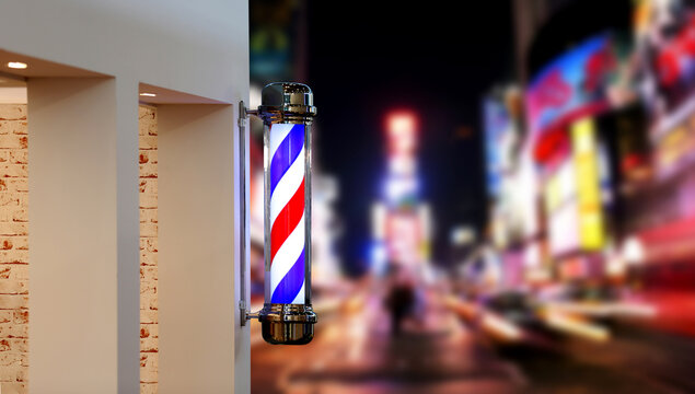 Barber shop pole against modern city street at night and empty space for text