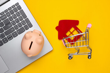 Save up for housing. Laptop, piggy bank, shopping trolley with house figure, wallet on yellow...