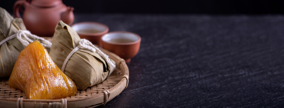 Alkaline rice dumpling zongzi - Traditional sweet Chinese crystal food on a plate to eat for Dragon Boat Duanwu Festival celebration concept, close up.