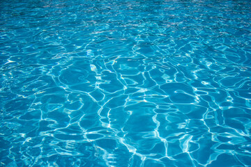 Fototapeta na wymiar Azure water outdoor swimming pool with reflections of sunlight