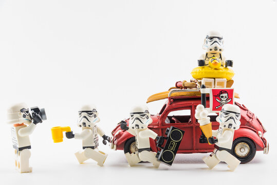 Bangkok, Thailand - March, 24, 2020 : Lego star wars stormtrooper enjoy on vacation, to the beach by taking the red vintage car.