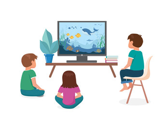 Children watch TV. Boys and a girl are sitting on the floor and watching an entertainment program about the ocean