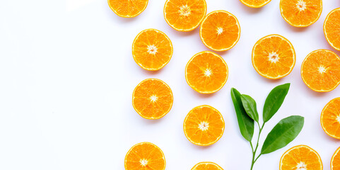 Orange fruit with leaves on white background.