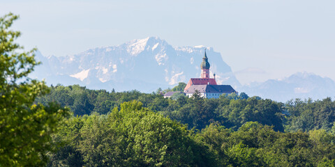 Fototapeta na wymiar Fantastic panorama with Kloster Andechs (Andechs Abbey) and Zugspitze mountain