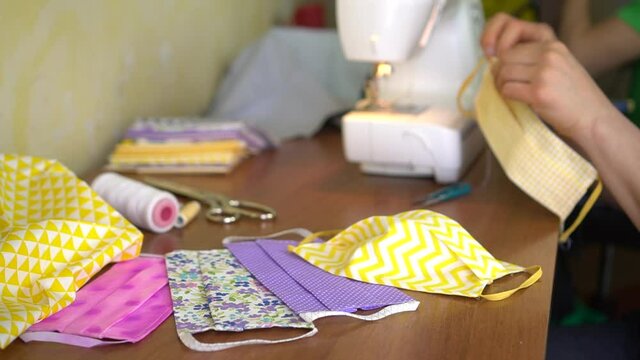 Eco-friendly Upcycled mask, Cotton Face Mask. A Woman Sew at Home a Fabric Face Mask Washable and Reusable