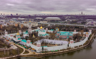 A view from above of the Novodevichy Convent, in the background is a football stadium and city buildings. Orthodox shrine, aerial photo