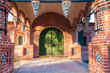 Ornate entrance of Yaroslavl Old Believers red brick church in warm sunlight, the Golden Ring of Russia