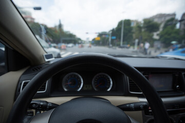 Driving car on city road awaiting in front of the zebra crossing