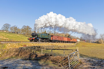 Fototapeta na wymiar GWR Large Prarie No. 4144 powers past Top Field with the first working of the Keighley and Worth Valley Railway Steam Gala, the 09:05 goods from Keighley on Friday 6th March 2020.