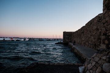 sunset over the sea with old town