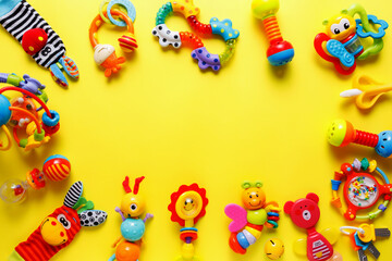 Fototapeta na wymiar Baby kids toys on yellow background. Top view