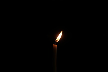 burning candle in the dark