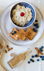 Healthy breakfast. Oat Flakes Porridge with toasts.