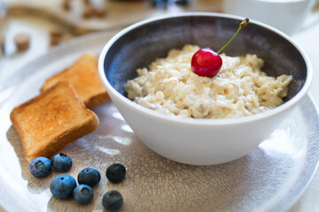 Healthy breakfast. Oat Flakes Porridge with toasts.