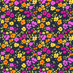 Seamless floral pattern for design. Small pink and yellow flowers. Dark background. Modern floral texture. A allover floral design in bright colors. The elegant the template for fashion prints.