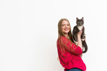 happy young woman holding in arms fluffy cat and looking at camera isolated on white
