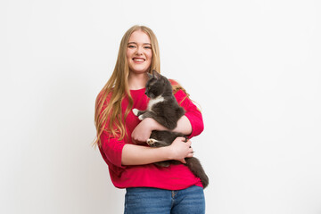 Fototapeta na wymiar happy woman holding in arms fluffy cat isolated on white