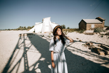 Portrait of a young beautiful woman in a hat outdoors