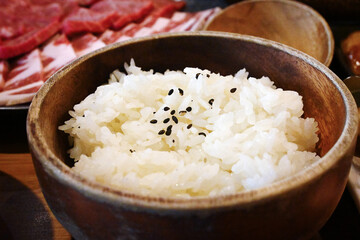 A wooden bowl full of rice