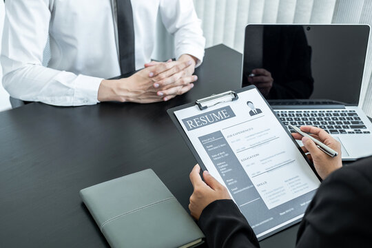 Office executives are interviewing job applicants in the meeting room