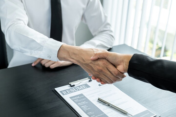 Office executives are interviewing job applicants in the meeting room