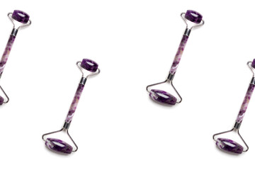 Pattern isolated on white. Purple jade face lifting massage rollers arranged diagonally