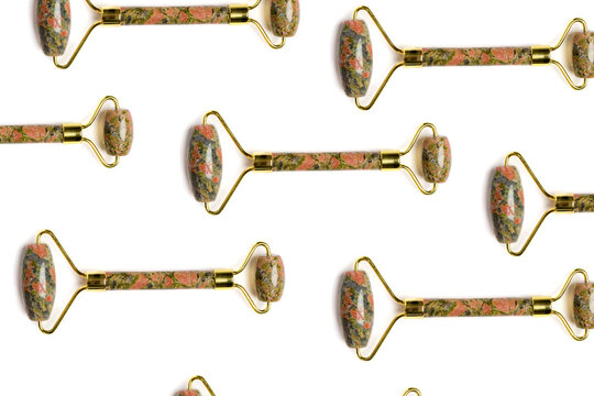 Multicolored jade roller massager isolated on white with pattern design