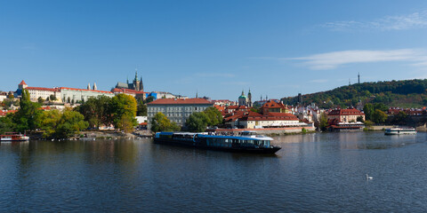 Pleasure boat on the Vltava pier in the fall. View of Prague.