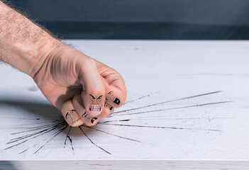 Fist hitting table. Simulation of bullying or sexist violence