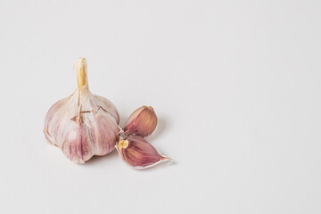 Whole head and cloves of purple garlic on a white background. Isolate.  Copy space