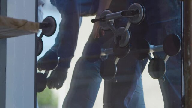 Glass spider fittings. Detail shot of workers