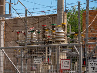 Transformer station near the power station. High voltage electrical wires.