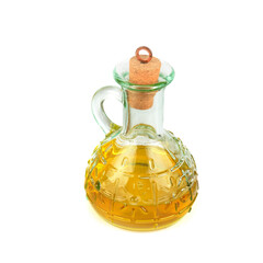 Glass jug with oil on white background.