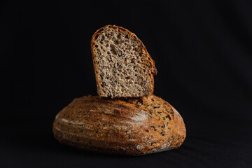 Whole wheat bread on black background