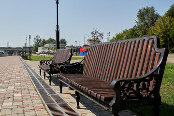Wooden benches on the river embankment in Gomel, Belarus.