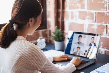 Asian woman virtual conference meeting video call and work at home office