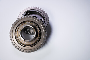 A two new gear part on a gray background. The concept of new parts and spare parts