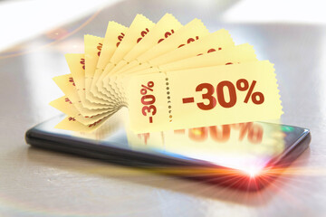 Hand holding smart phone with promo code coupons