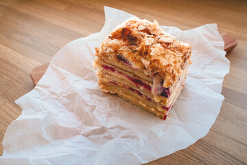 Homemade layer cake with raspberries on parchment