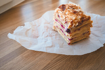 Homemade layer cake with raspberries on parchment
