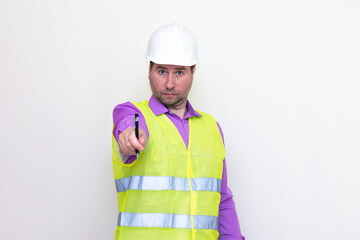 Portrait middle age of caucasian worker wearing hard hat holding pen makes all kinds of grimaces on white studio background.
