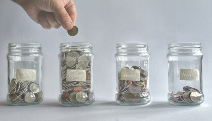 Follow your dreams concept.Human hand put coin in jar.Economy saving money concept invest for future money savings financial education wealth management