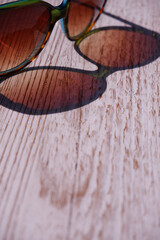 Sunglasses reflected  onto a wooden background