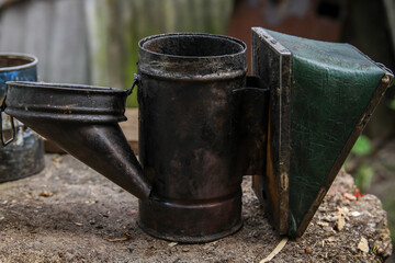 Old bee smoker. Tool of the beekeeper. Everything for a beekeeper to work with bees.